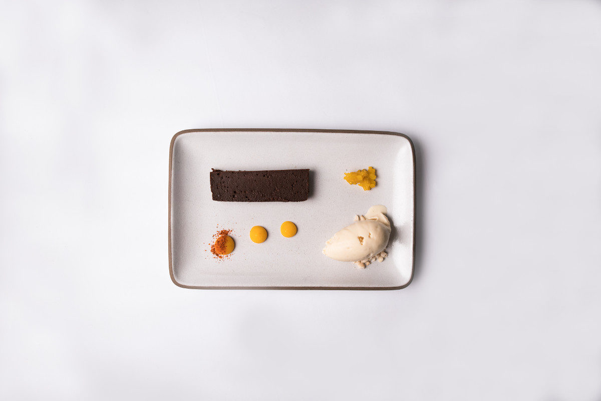 Dessert course by Chef Michael Beckman: Callebaut chocolate terrine with peanut butter ice cream local mango and Piment D’espellete. 